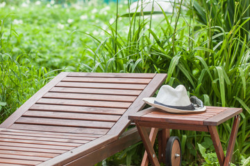 Wooden chaise longue and table. Rest in the open air. Nature. Country house. For your design.