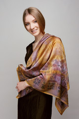 Portrait of beautiful smiling girl with colorful silk shawl