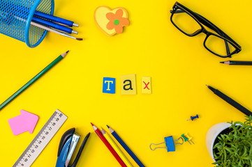 Time for Taxes. Money Financial Accounting. Taxation Concept with office suplies at yellow background