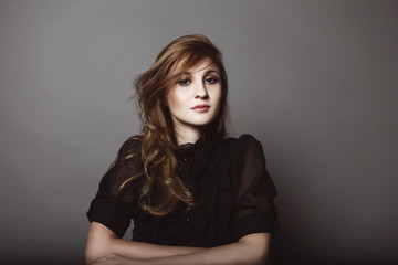 beautiful female sitting with hands crossed