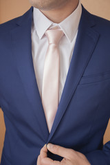 A man in a beautiful suit with a soft tie