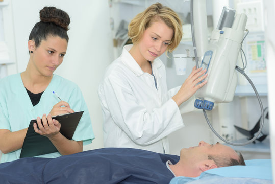 radiologic technician with doctor during magnetic resonance exam procedure