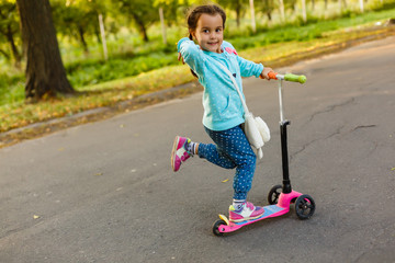 Fototapeta premium Beautiful girl driving scooter on rural road outdoor in nature