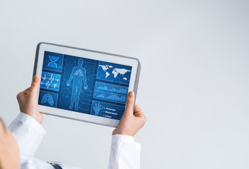 Close of female doctor hands working with tablet pc computer