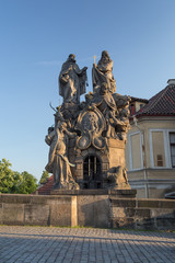 Fototapeta na wymiar Statues of John of Matha, Felix of Valois and Saint Ivan on the south side of the Charles Bridge (Karluv most) in Prague, Czech Republic, on a sunny day.