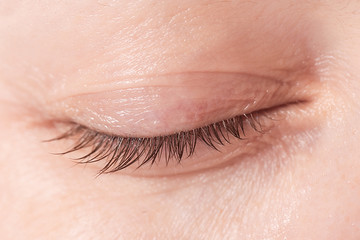 
Close up view of a closed woman eye - no make up