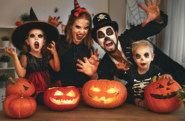 happy family mother father and children in costumes and makeup on  Halloween.