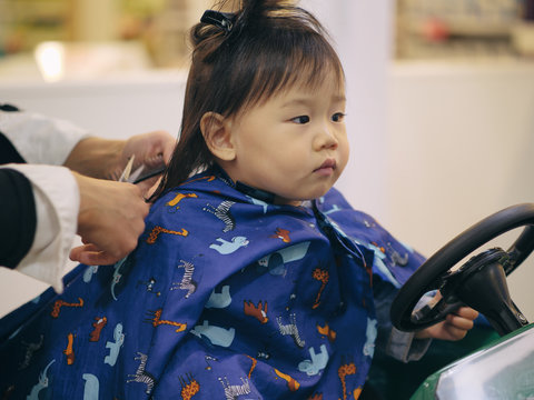 Asian baby girl do hair cut first time in hairdressing shop Stock Photo |  Adobe Stock