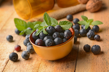 pile of blueberries in the terracotta bowl