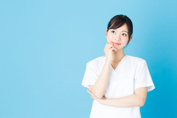 portrait of asian nurse isolated on blue background