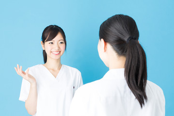 portrait of asian nurse isolated on blue background
