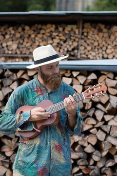 Man playing ukulele outdoors