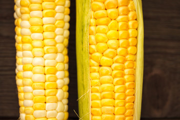 Fresh corn on cobs on  wooden table, closeup