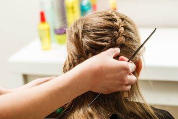 Naklejka premium Blonde toddler girl getting her hairstyle done