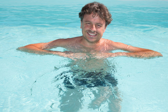 Photo of handsome man in swimming pool