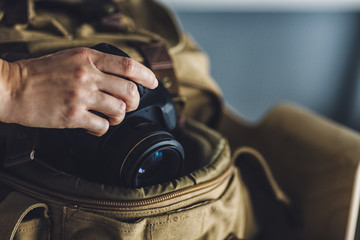 Photographer Putting her Camera into her Rucksack