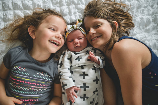 Three Sisters Laying Together