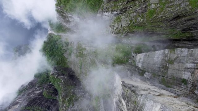 Aerial shot view from above is from a great height to the precipice between the rocks, fog. Norway. Europe. Rotating the camera. Preikestolen Landscape, Prekestolen, Preacher's Pulpit or Pulpit Rock.