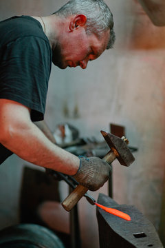 blacksmith makes a knife