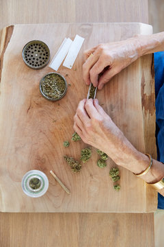 Senior woman's hands rolling a medical marijuana joint