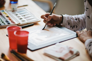 Girl artist paints watercolors