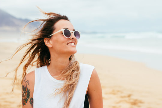 Portrait of smiling and happy woman on the beach