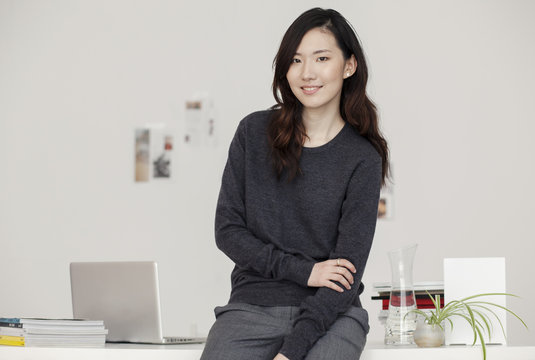 Portrait of a beautiful woman at the desk in the office