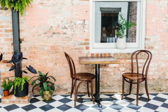 Fototapeta A lounge area with seating / checkered floor & vintage brick walls.