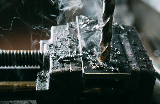 Drilling a hole into a steel plate close up