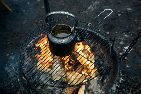 Boiling water for thee in a kettle on the campfire