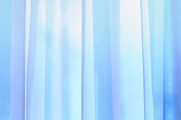 A wave of illuminated soft and gentle colored curtain made of lightweight fabric.