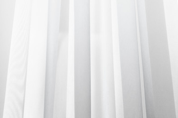 Obraz premium A wave of illuminated soft and gentle white curtain made of lightweight fabric.