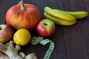 healthy concept with lemon, Pumpkin, bananas, ginger put and centimeter