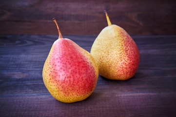 two pears on a dark wooden background