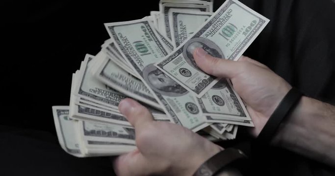 bundle of dollars in the hands