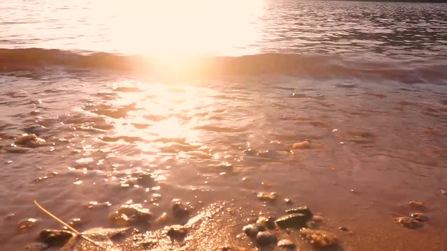 A sunset view of waves hitting the shoreline of a lake in North Carolina.