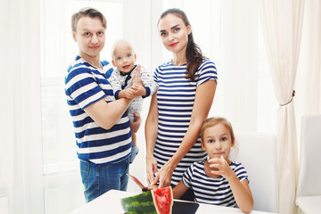 Fototapeta na wymiar Happy family eating watermelon