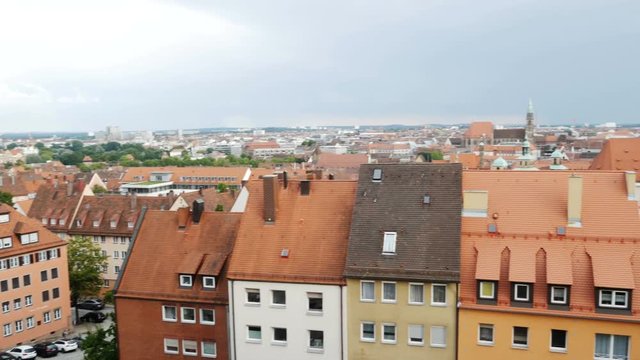 NUREMBERG, GERMANY August 14, 2017: Church and old town with cloudy sky by day timelapse, zoom out - a view on the old town nuremberg with red roofs and St. Sebald church
