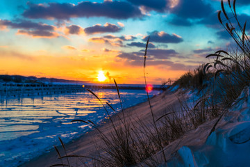 sunset on Lake Michigan in the Winter - obrazy, fototapety, plakaty