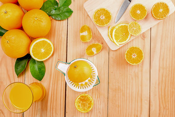 Fototapeta na wymiar Orange juice in glass and fresh citrus around on wooden table background fruit product display or montage