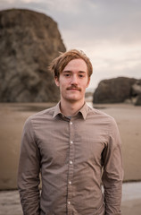 portrait of a young men in his early twenties at the beach