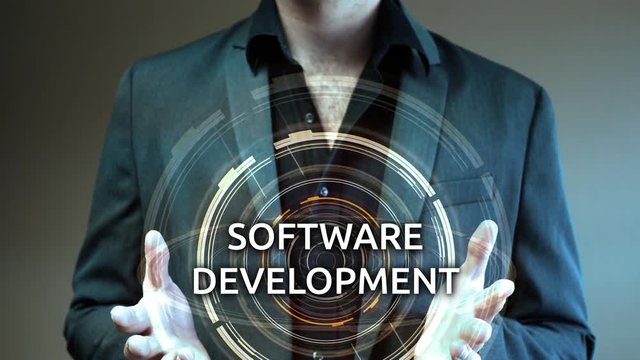 A businessman holds up a futuristic glowing aura reading Software Development