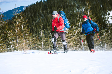 Two climbers are in the mountains.