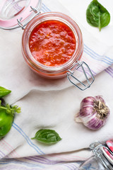 tomato sauce for pasta, hot pepper and basil top view.