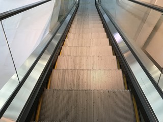 look down from top of escalator in shopping mall 