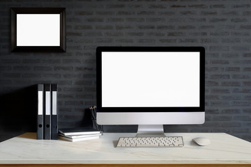 Mock up : Designer or Stylish workspace with Modern desktop computer, office supplies and notebooks over black wall at home or studio office. Blank screen for graphics display montage.