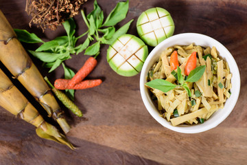 Thai Northern food (Yum Nor Mai),spicy bamboo shoot salad with crab paste on wooden background