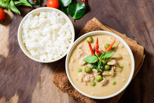 Thai food (Phanaeng curry),red curry with pork and cooked rice in a bowl on wooden background