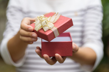 Woman open red gift box for giving in holidays