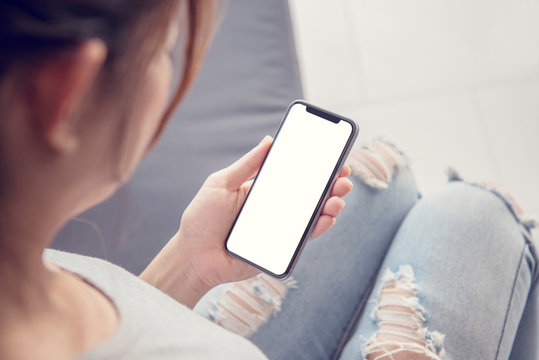 Close up of woman hand holding smart phone with blank copy space white screen background for create content.